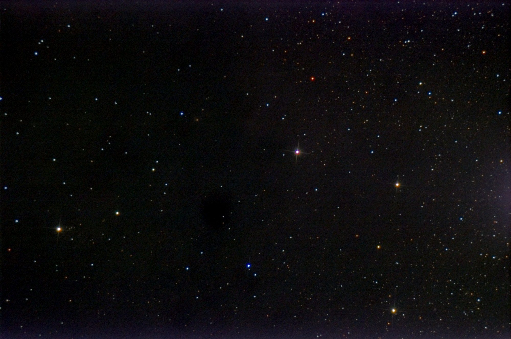 A dense field of stars, thicker towards the right, with no nebula visible