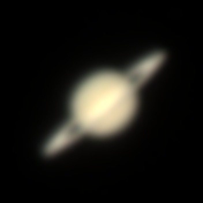 Saturn with its rings tilted, small and soft